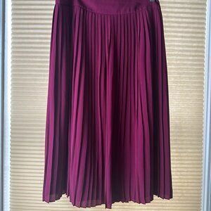 Pink, mid-length, pleated skirt.